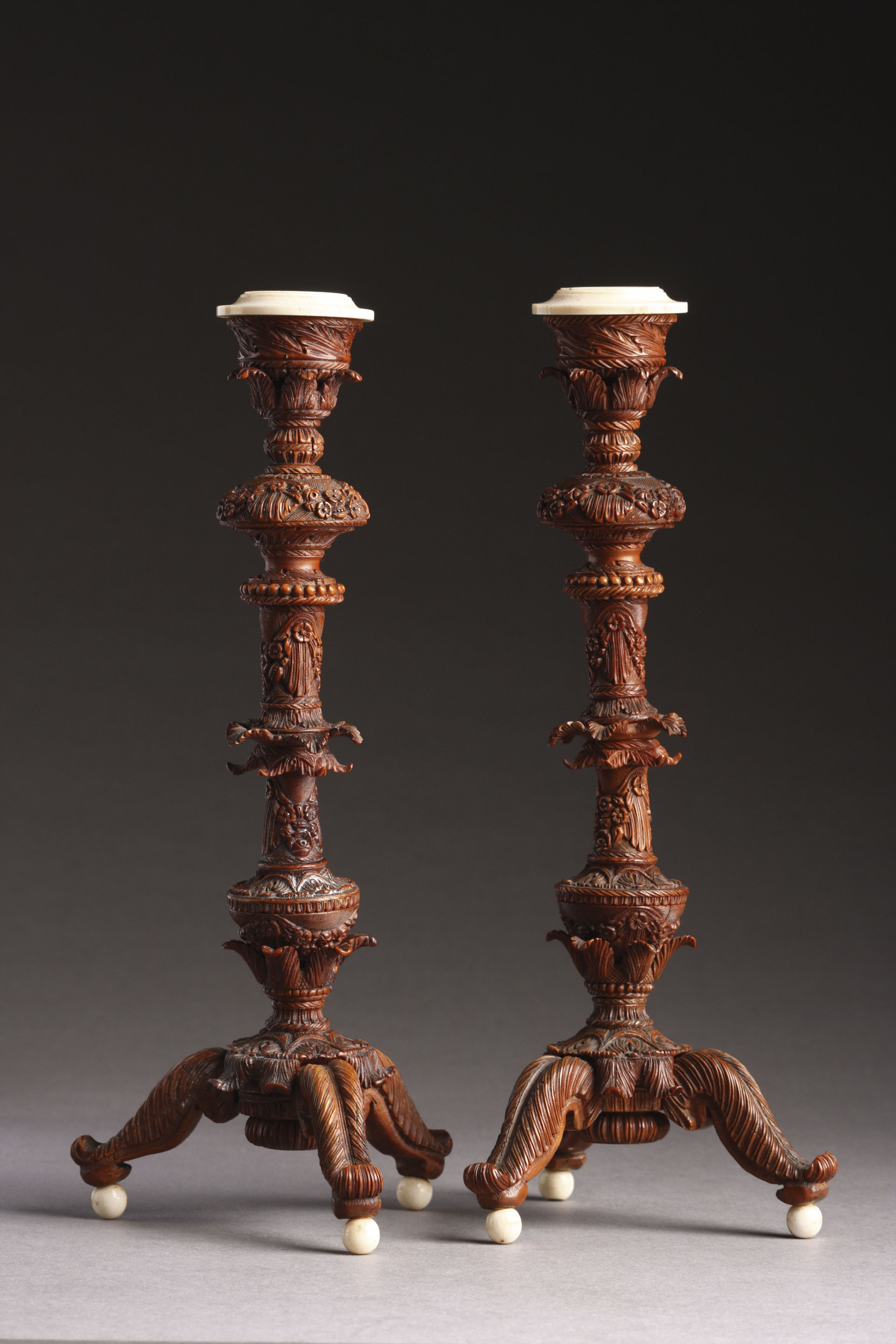 Pair of Crisply and Finely Carved Anglo Indian Coquilla Nut and Ivory Table Candlesticks